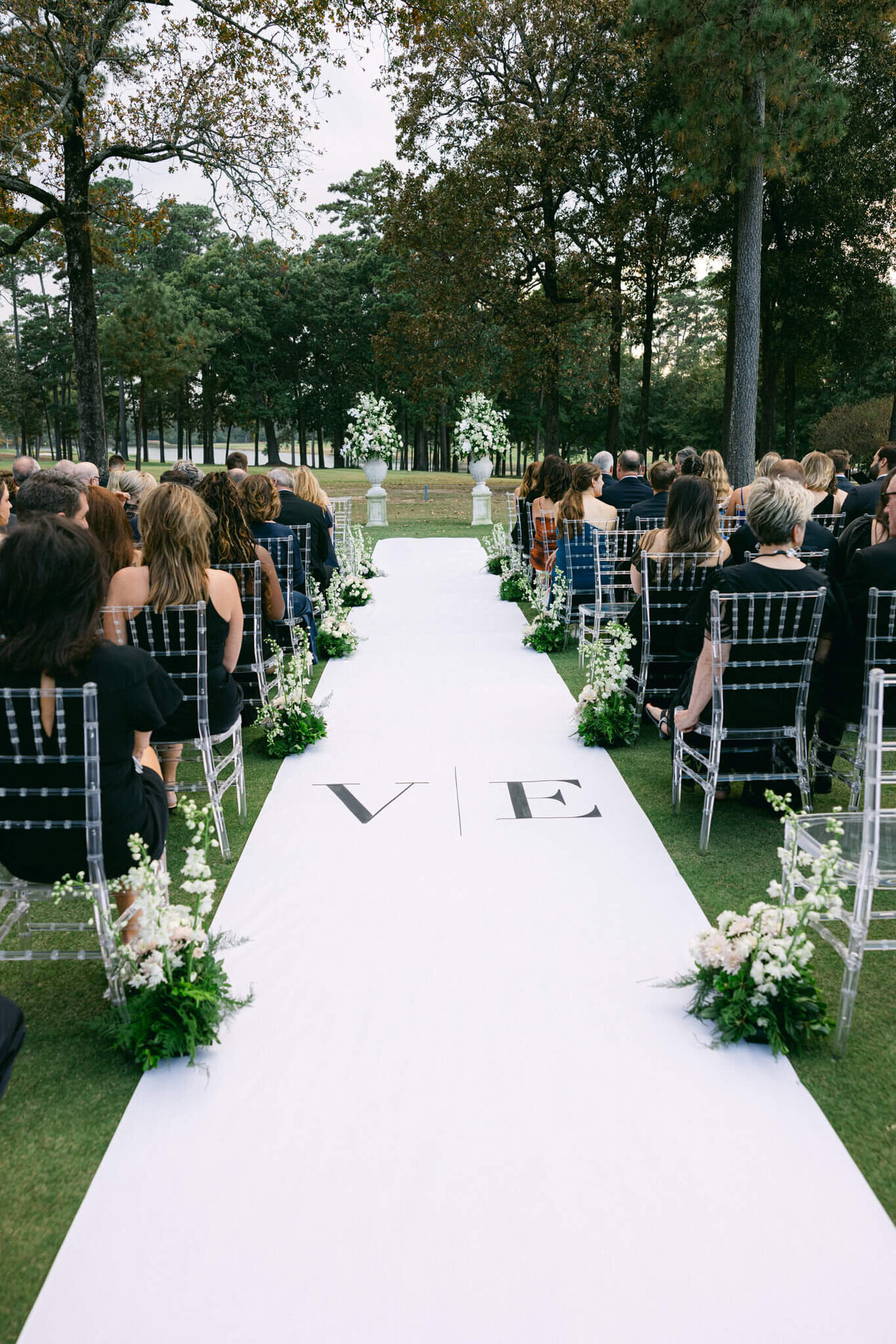 A wedding day photo of the aisle and guests sitting at the ceremony area