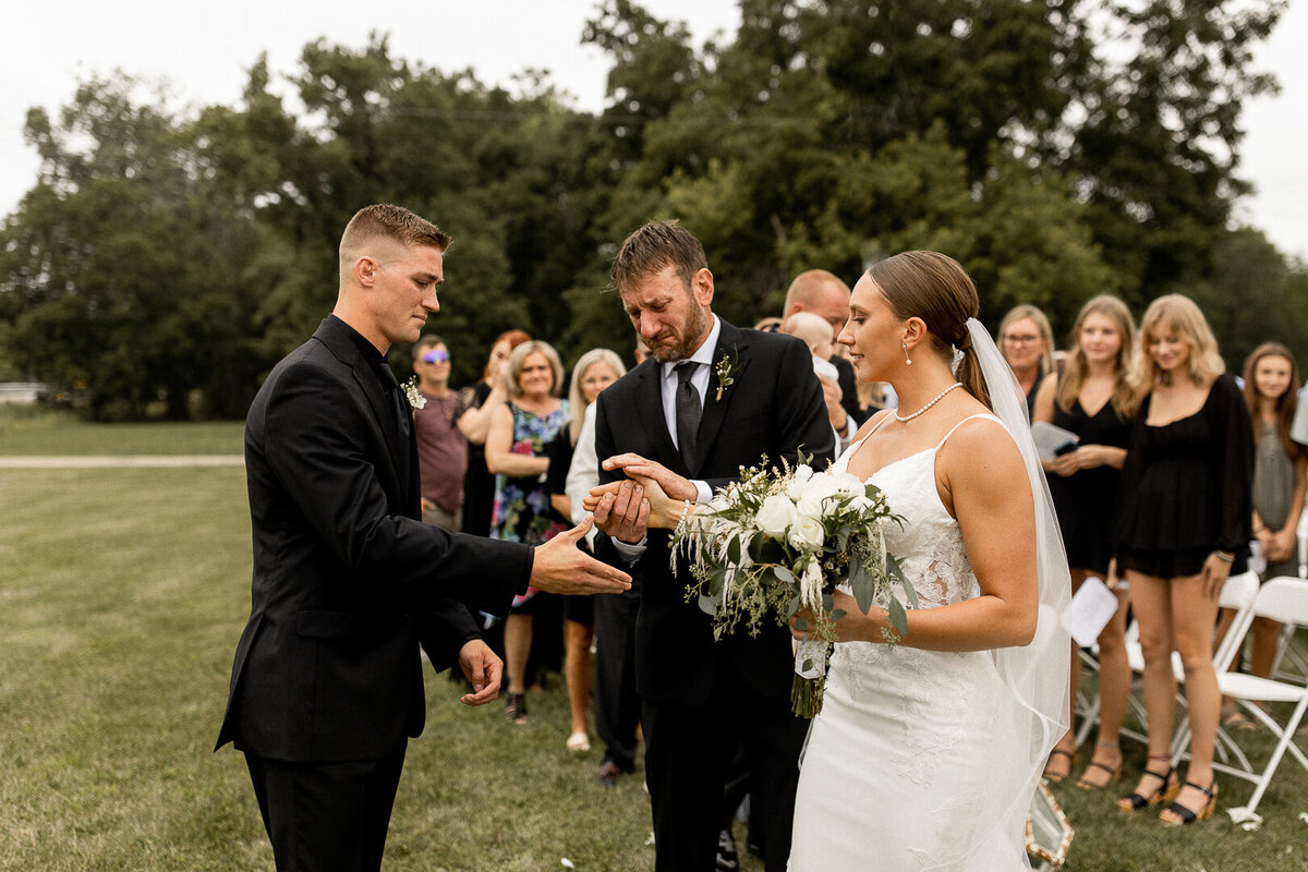 Father of bride giving his daughter away during Iowa wedding ceremony