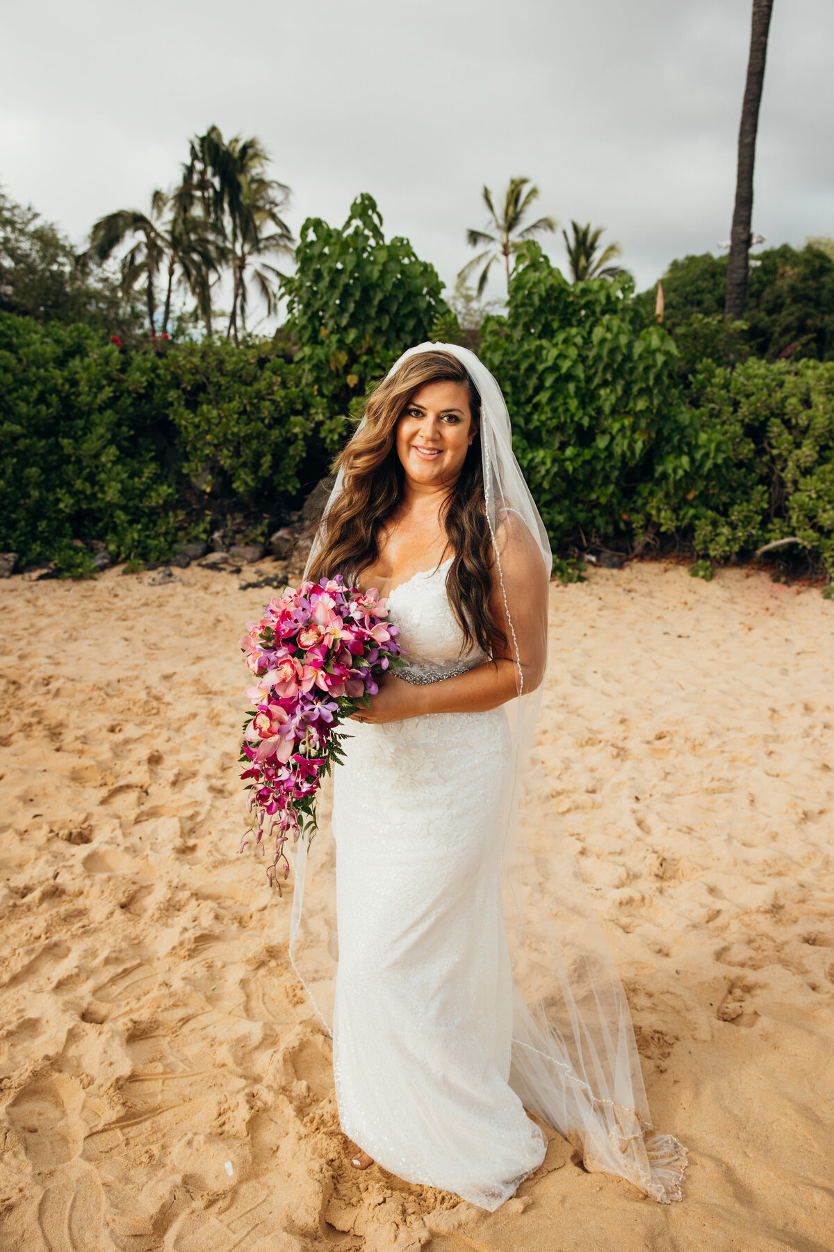 Maui Wedding Photographer captures bride holding pink bridal bouquet