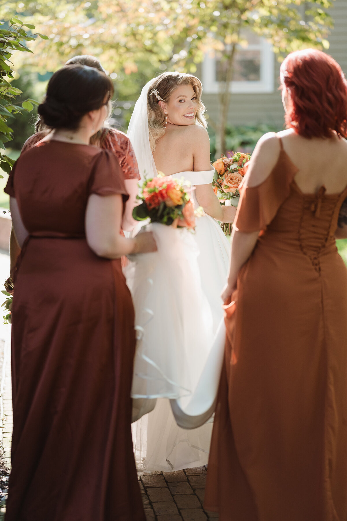 bridesmaids helping with the brides train