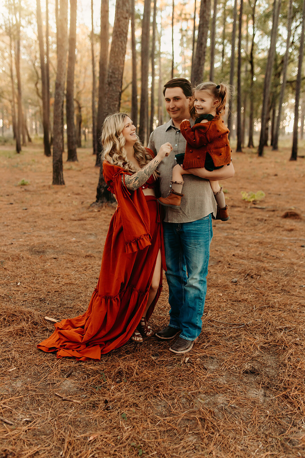 Kingwood TX family maternity portraits—expecting parents with toddler in forest setting