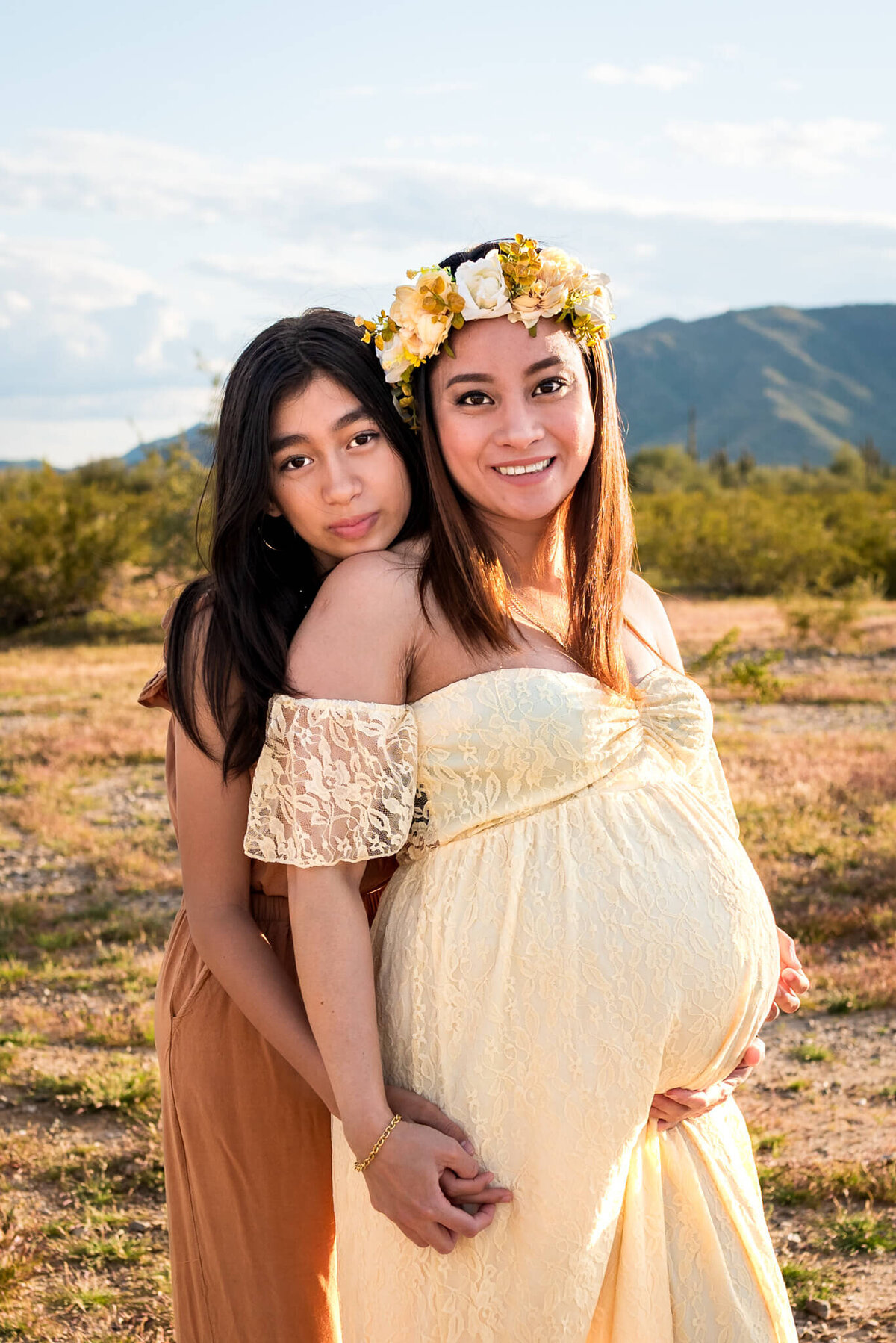 Maternity portrait with daughter hugging her pregnant mom in Arizona