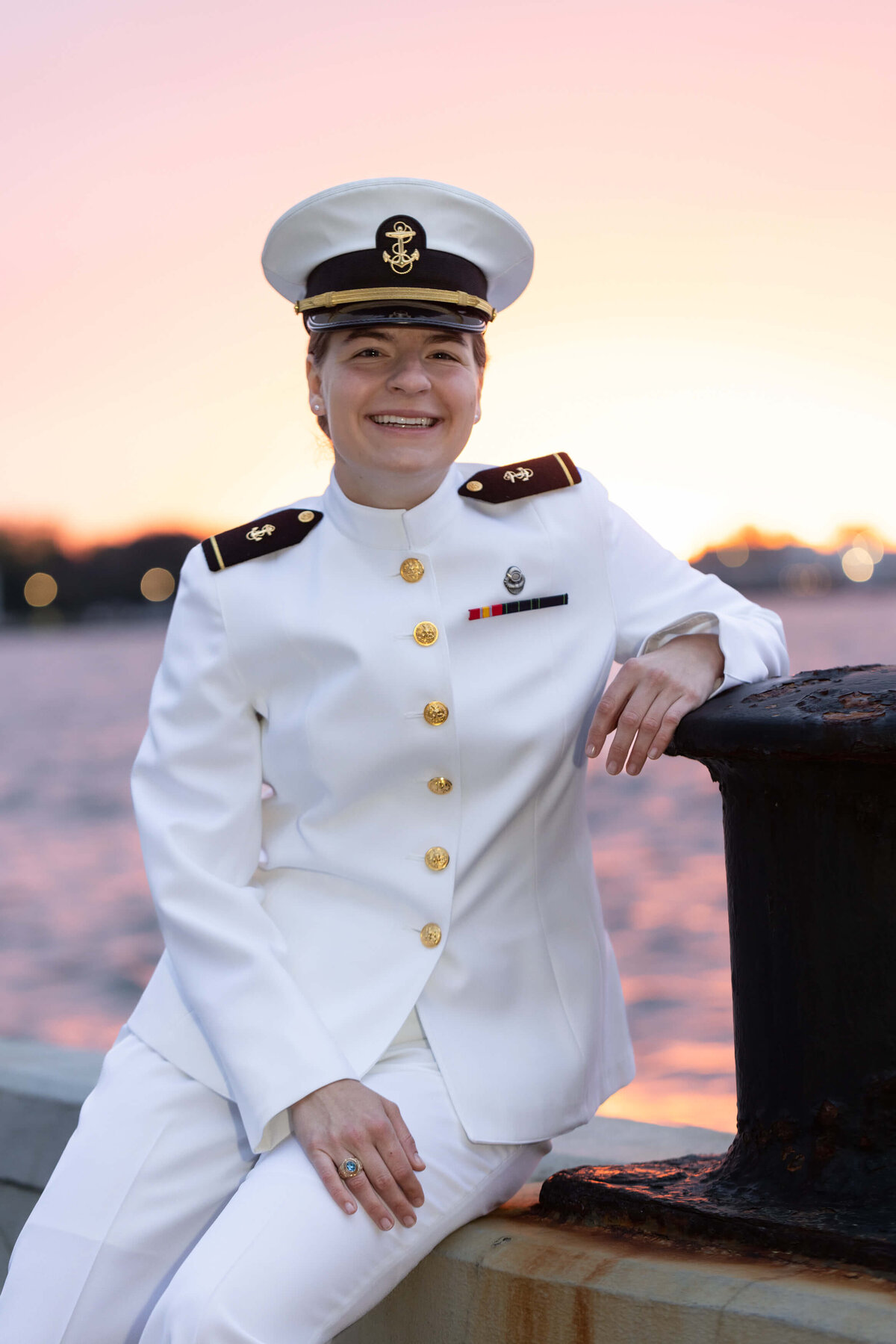 Naval Academy senior photo in white uniform at sunrise in Annapolis Maryland.