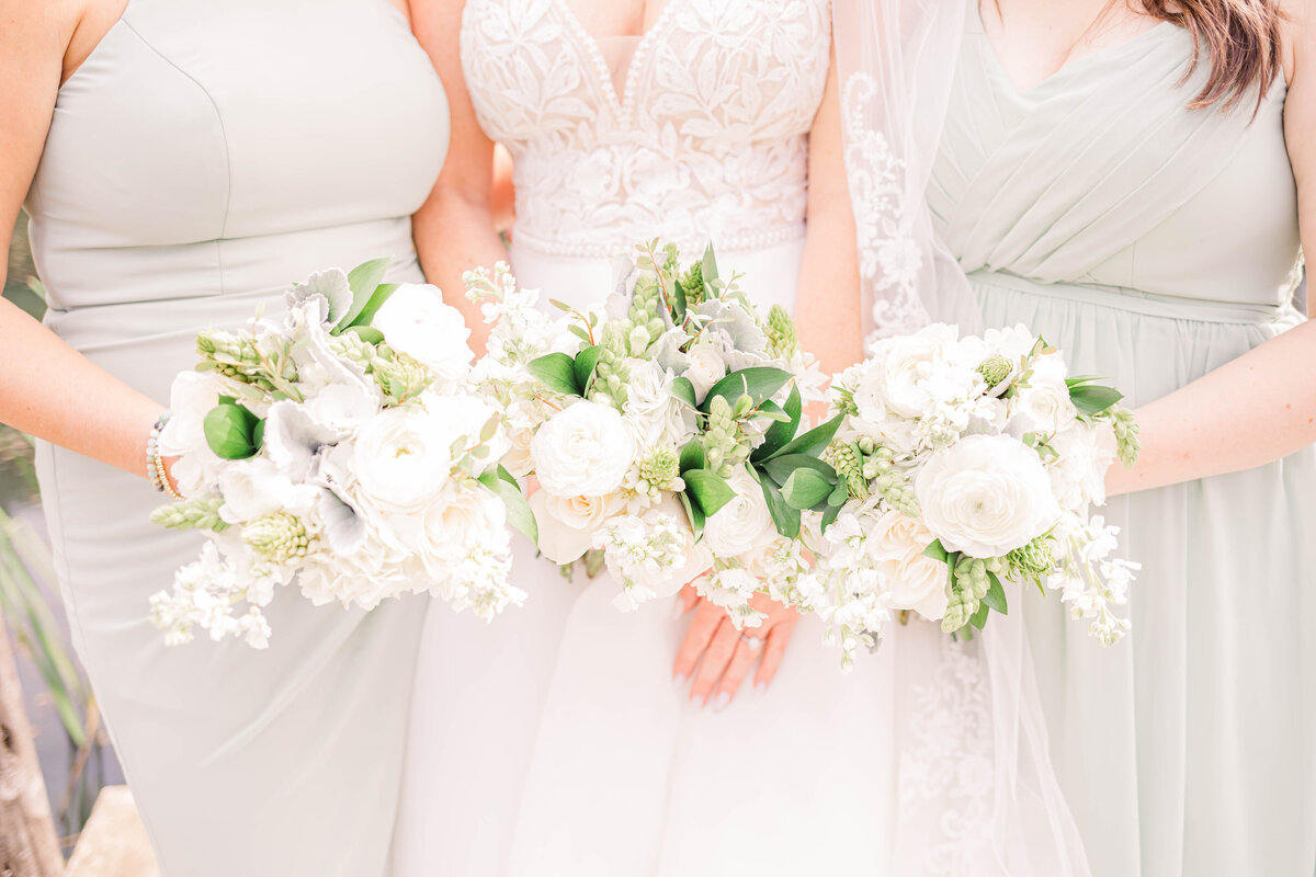 bridesmaids holding dreamy white florals