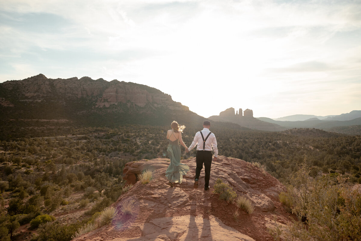 Couple standing against red rock backdrop during Sedona engagement session
