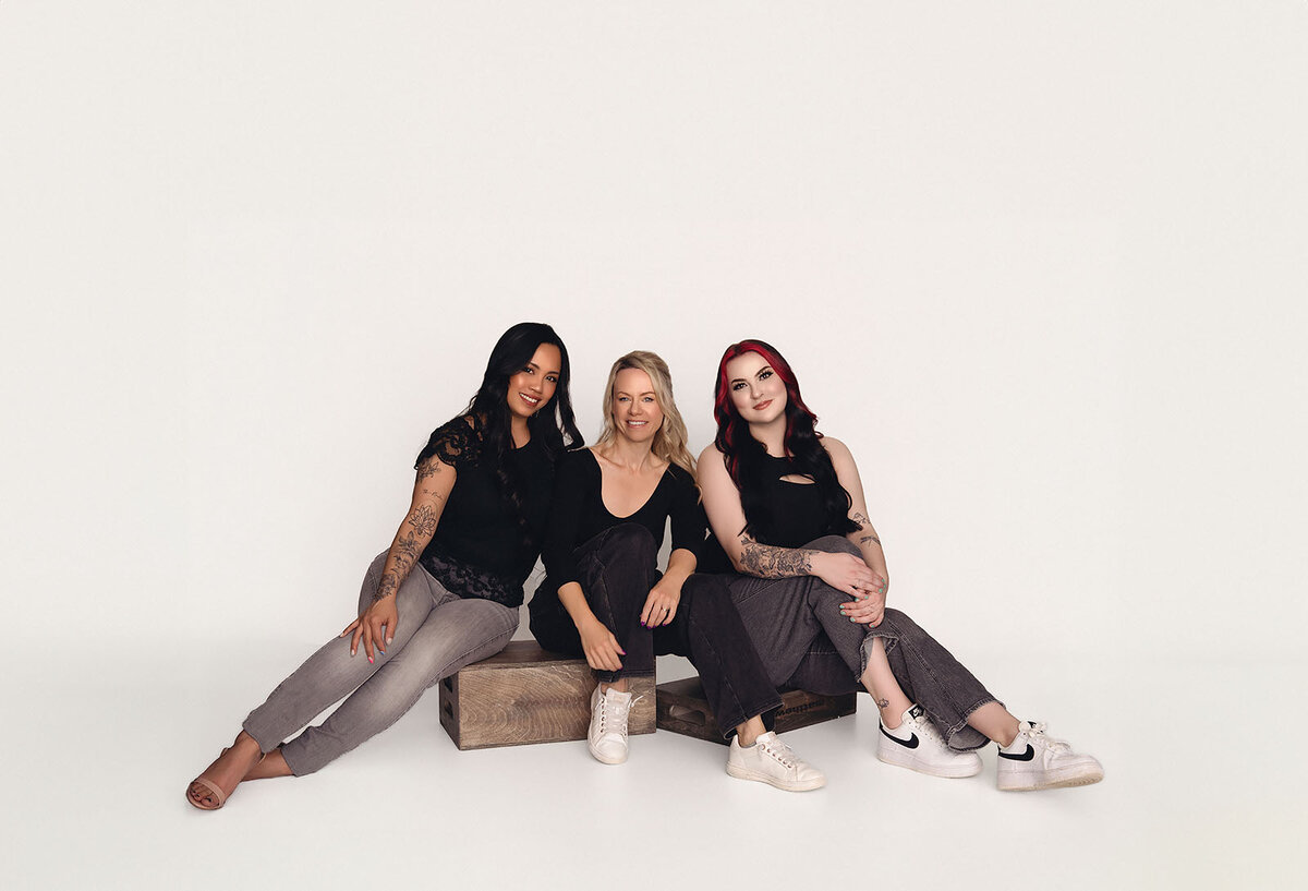 Three Vancouver Photographers pose on boxes for a photoshoot