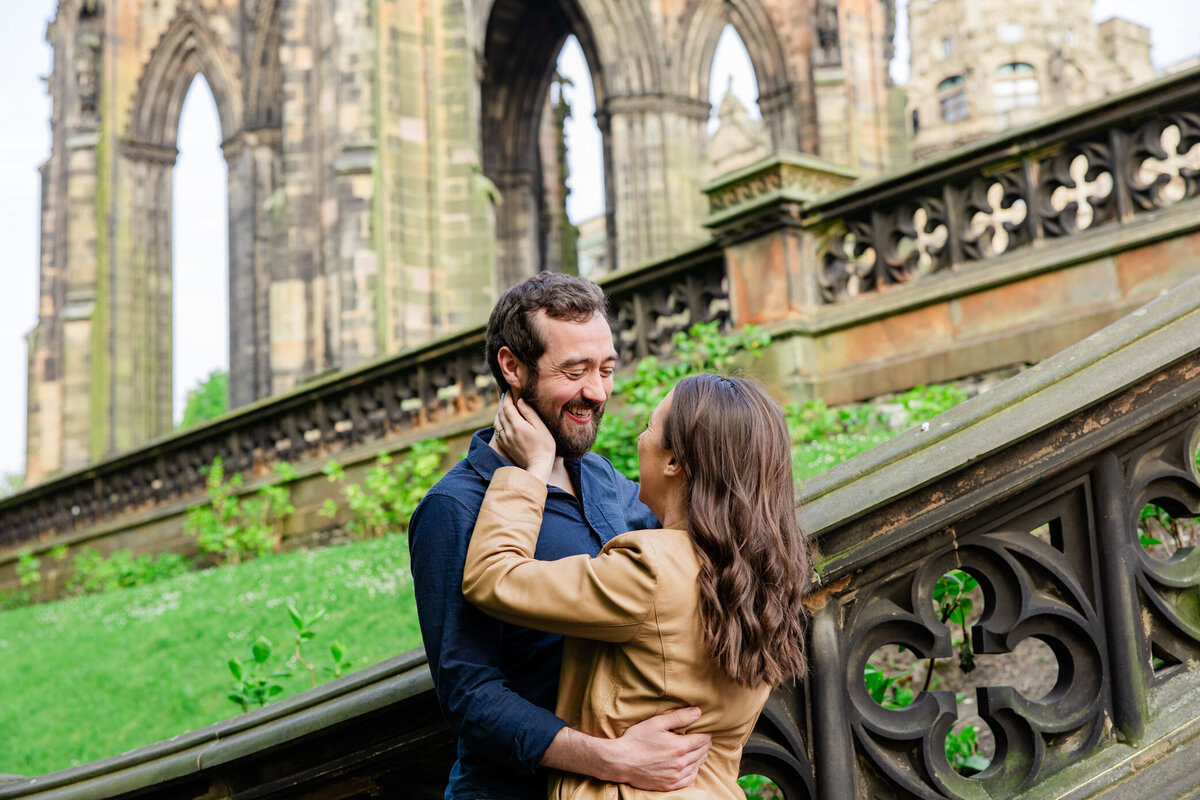 couple smiles near medieval architecture