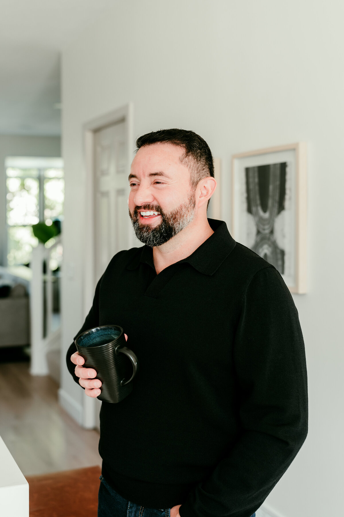 Professional online dating portrait of a man sitting at a cafe table with a coffee, captured for dating apps in Minneapolis by Shannon Kathleen Photography.