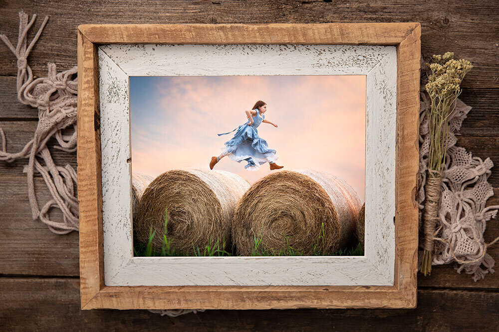 hay-jumping-farmhouse-frame-barnwood-fine-art-photography-child-cotton-candy-sky-wood-unique-centenial-state