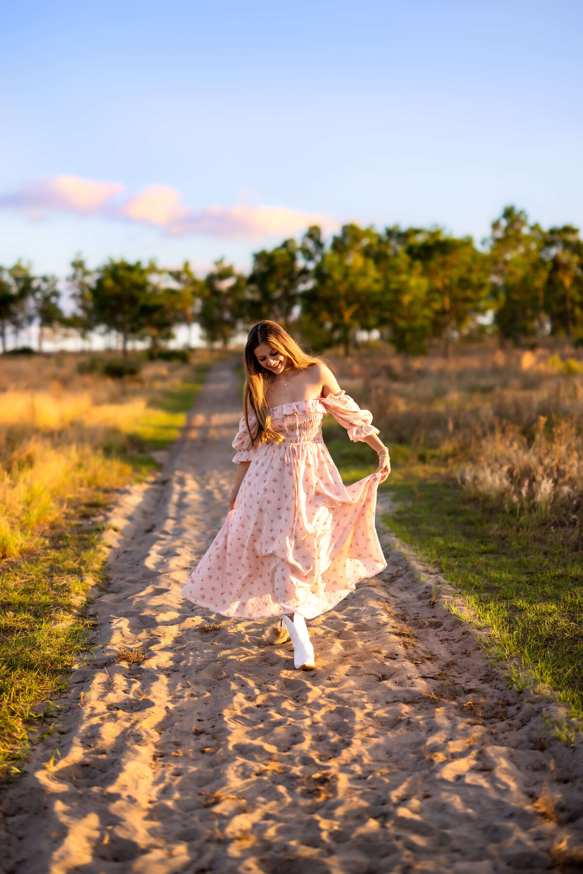 Senior walking confidently down a sandy trail in Celebration, Florida during sunset