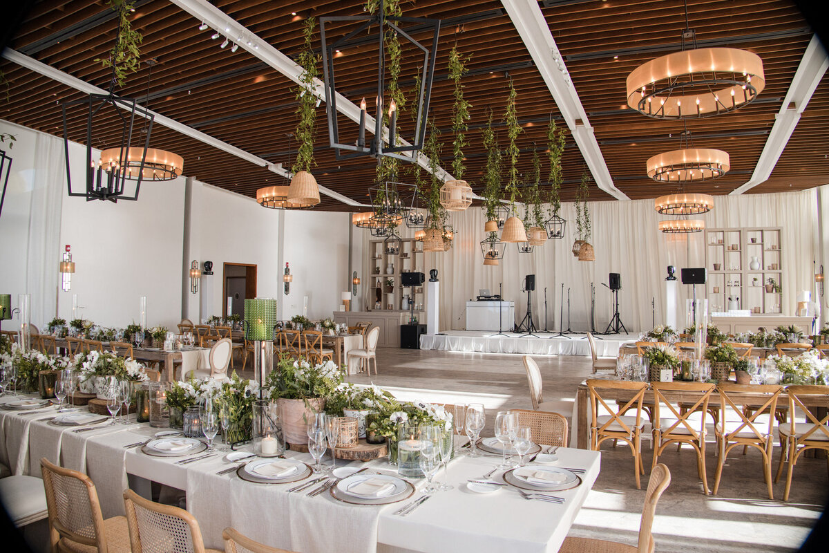 Earth tones, greens, and whites decorate a reception room  at a destination wedding in Puerto Rico