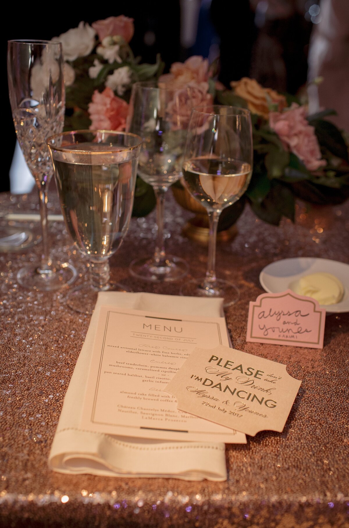 close up of menu with sparkle tablecloth during wedding reception.