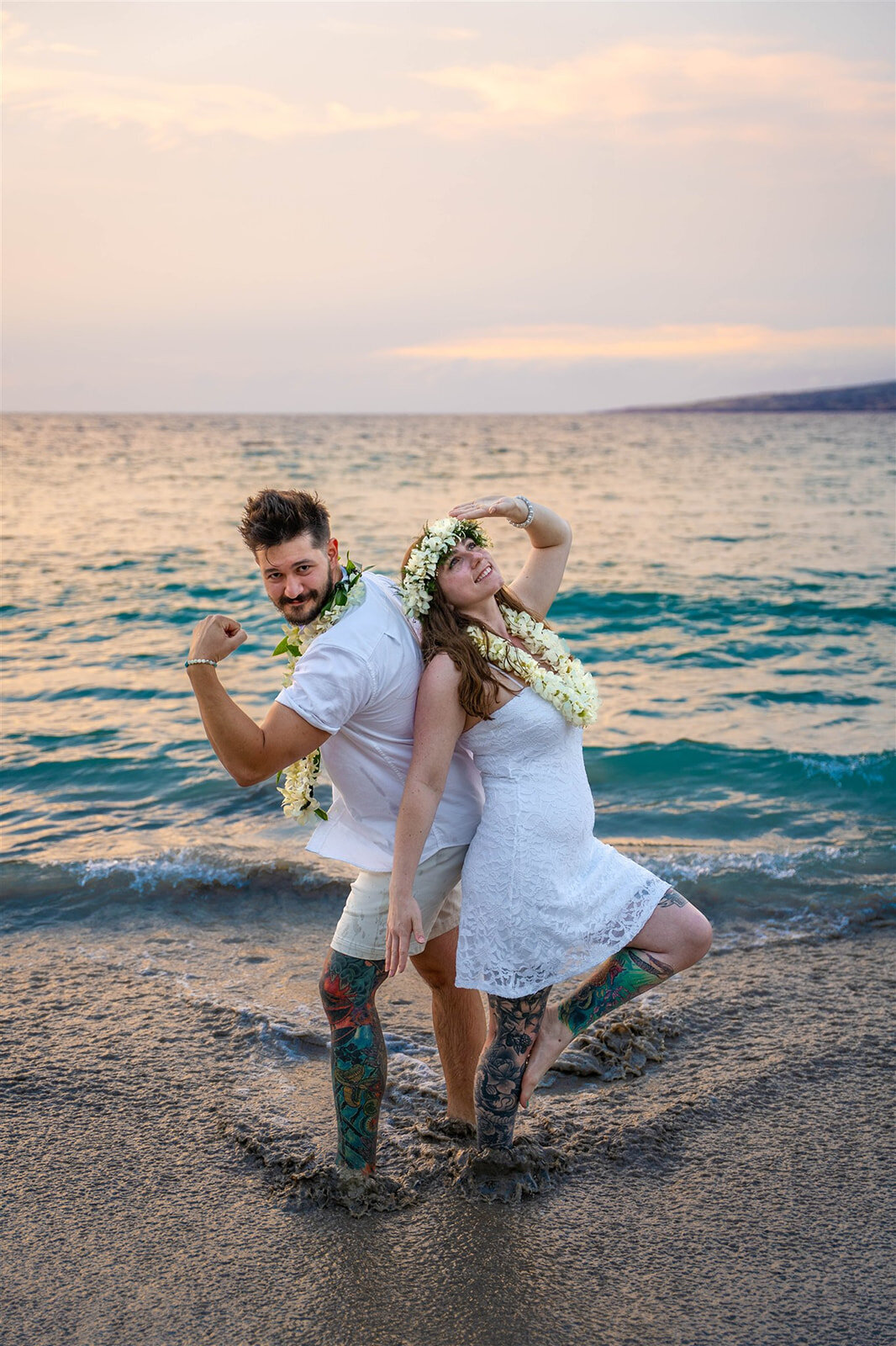 Couple making silly pose on beach for wedding photographers on the big island of hawaii
