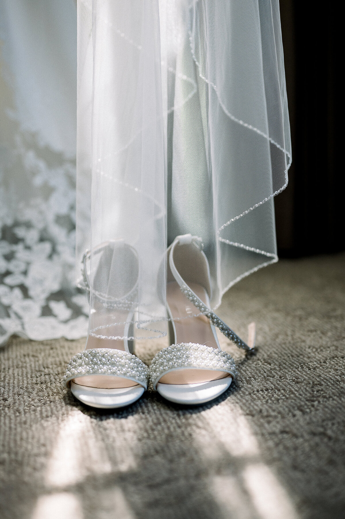 close up of wedding dress and bridal shoes