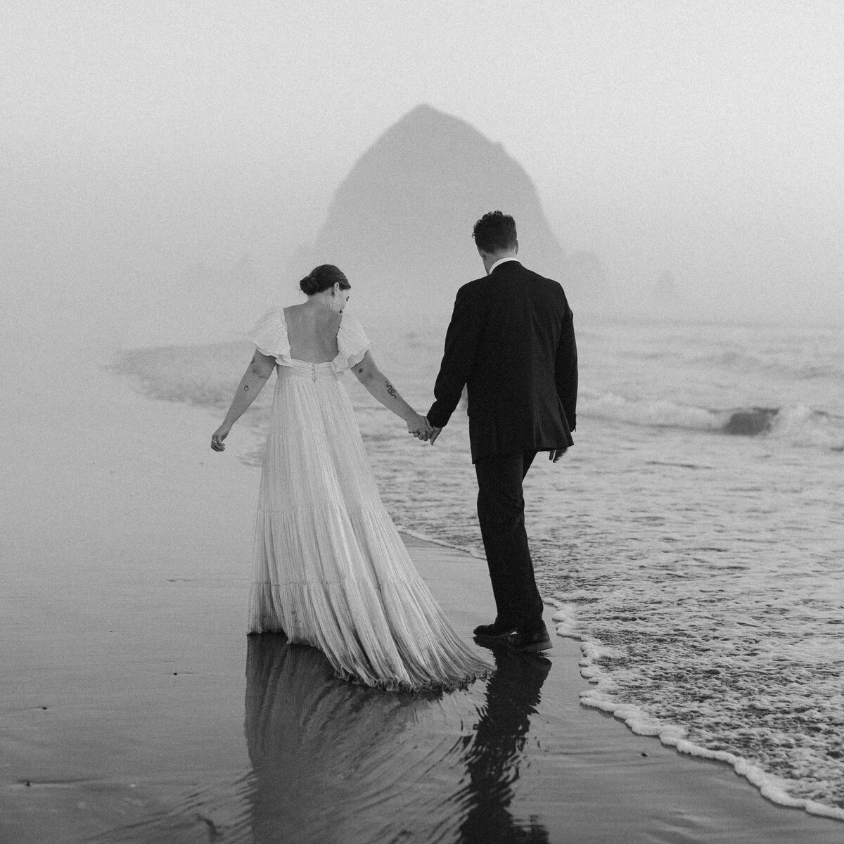 Bride and groom holding images after an elopement in Hawaii