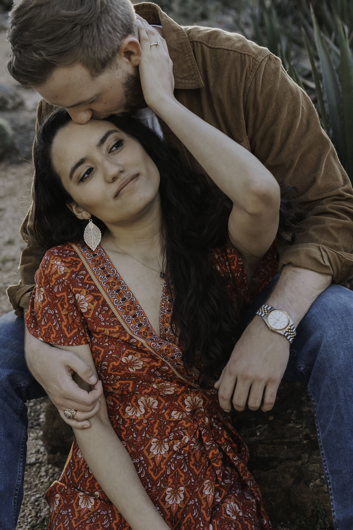 Man kissing womans forehead