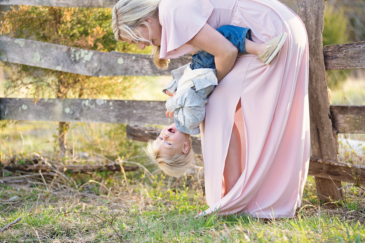 Expecting Mother is playing with her young son. Photo taken by Dripping Springs Texas based Lydia Teague Photography