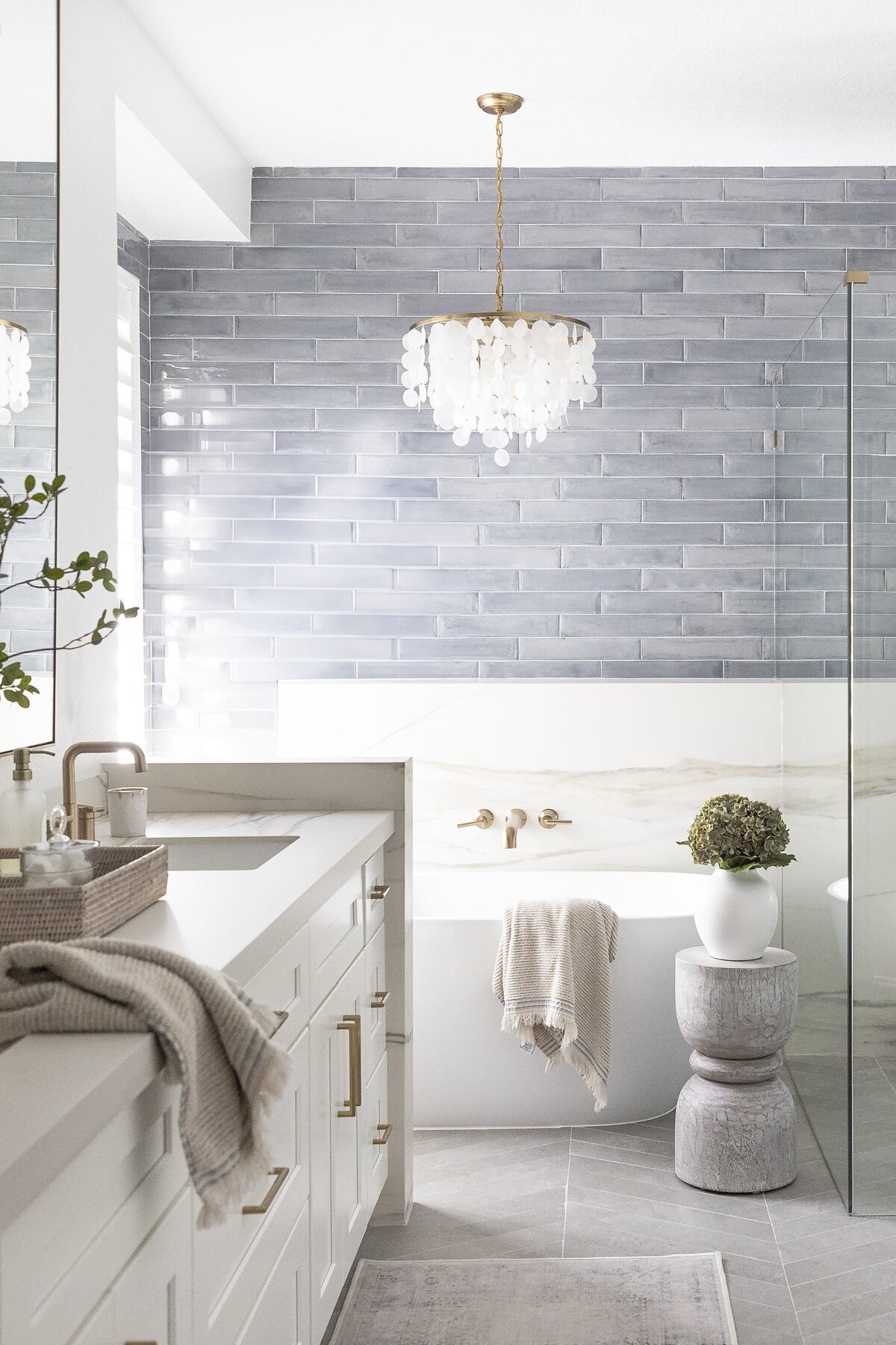 dewine design orlando interior designer contemporary coastal primary bathroom blue tile and standing white tub