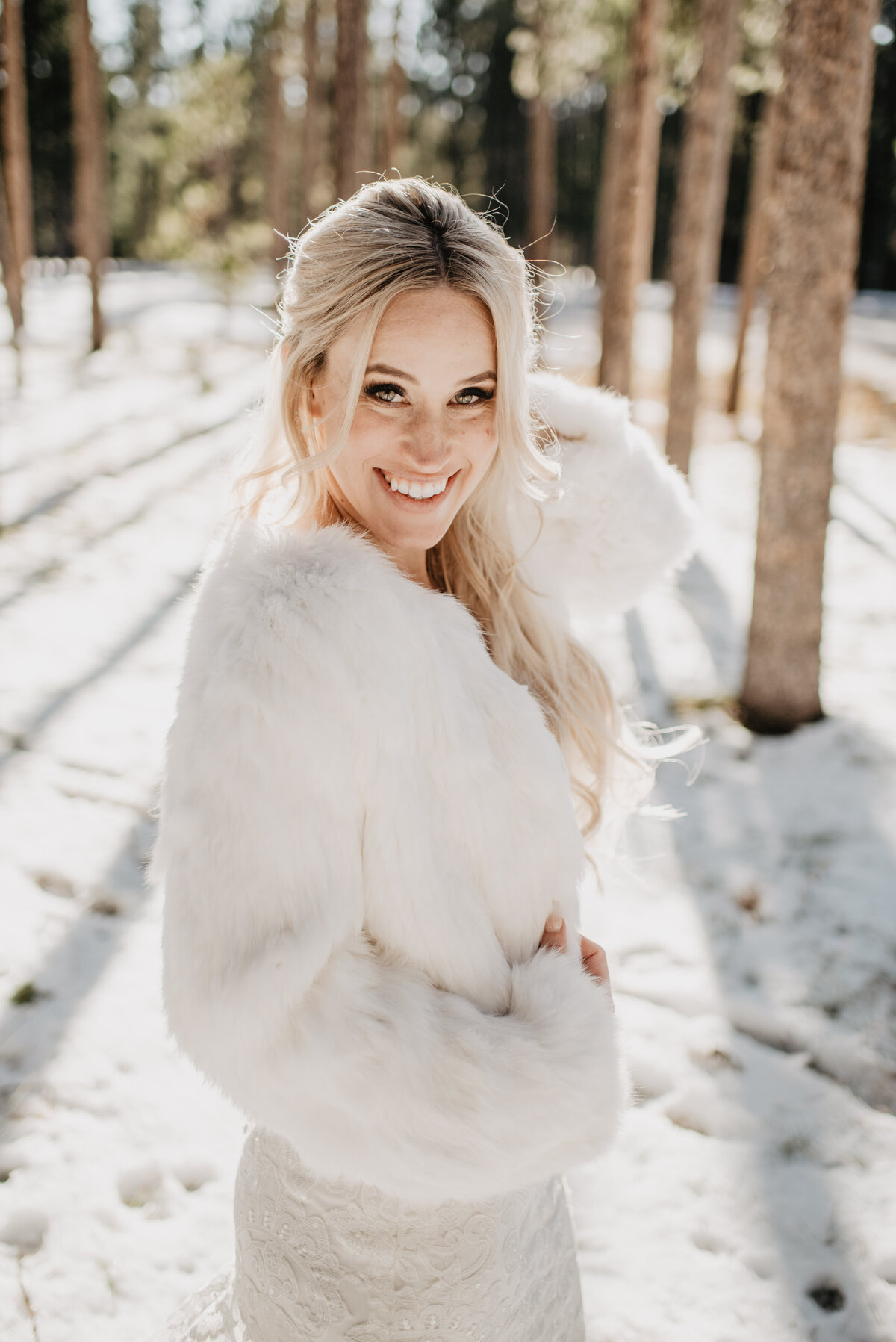 Jackson Hole Photographers capture bride wearing furry jacket during winter bridal portraits