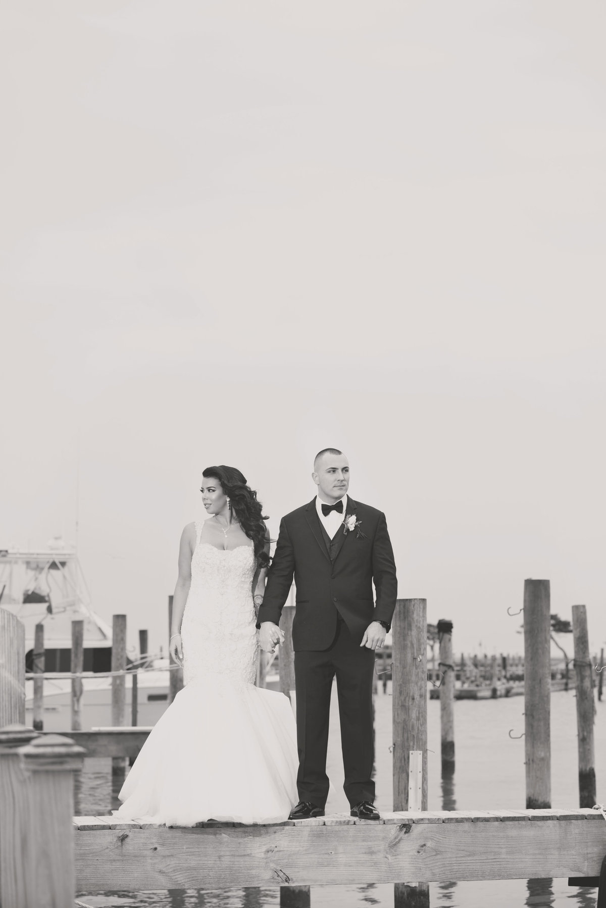 Bride and groom on dock at Captain Bills in black and white
