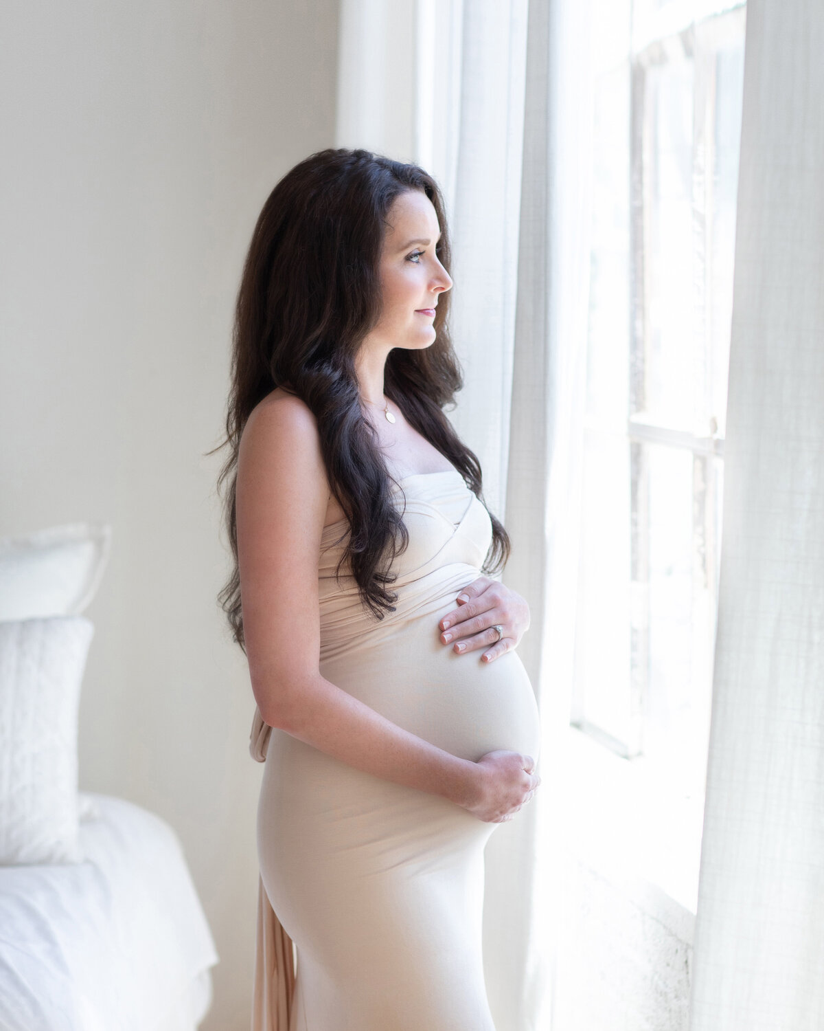pregnant-woman-looking-out-window