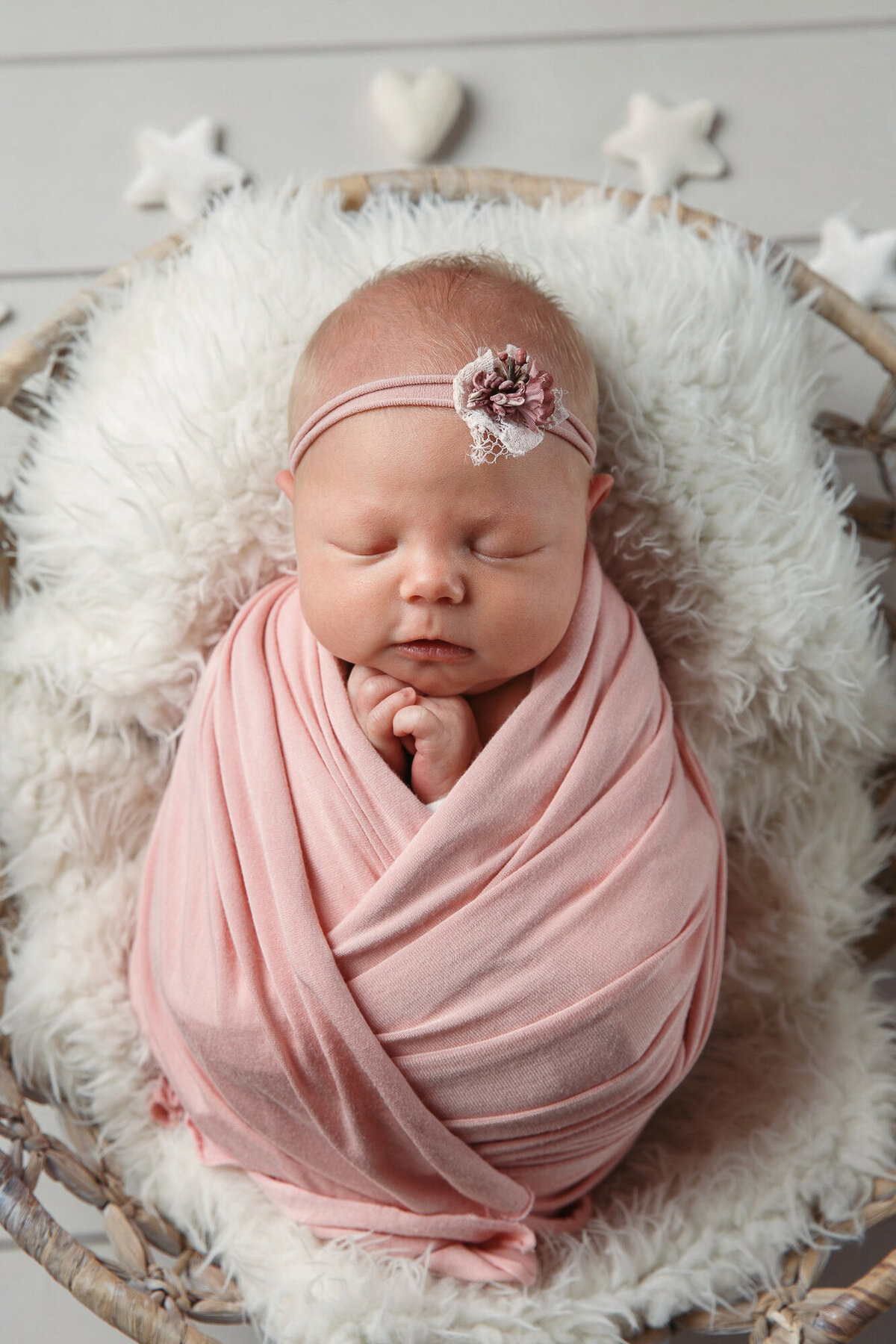 Photo of a pretty baby girl wrapped in pink