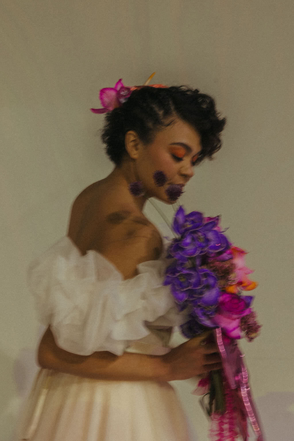 A person in a wedding dress holding a bouquet of flowers.