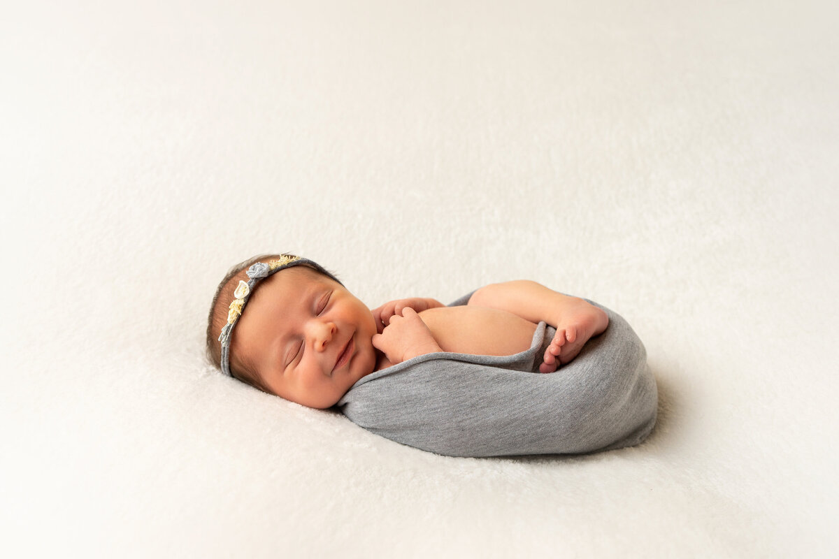 newborn-baby-posing-in-grey