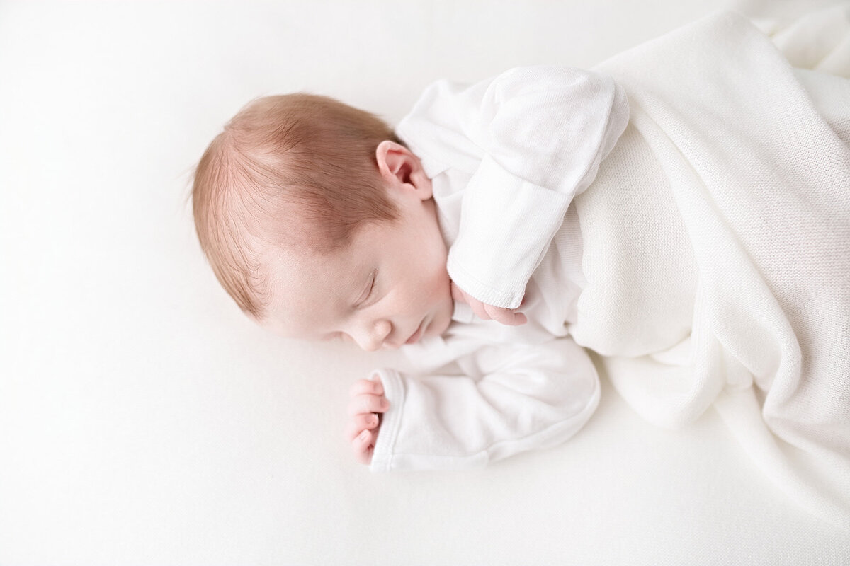 baby sleeping on bed