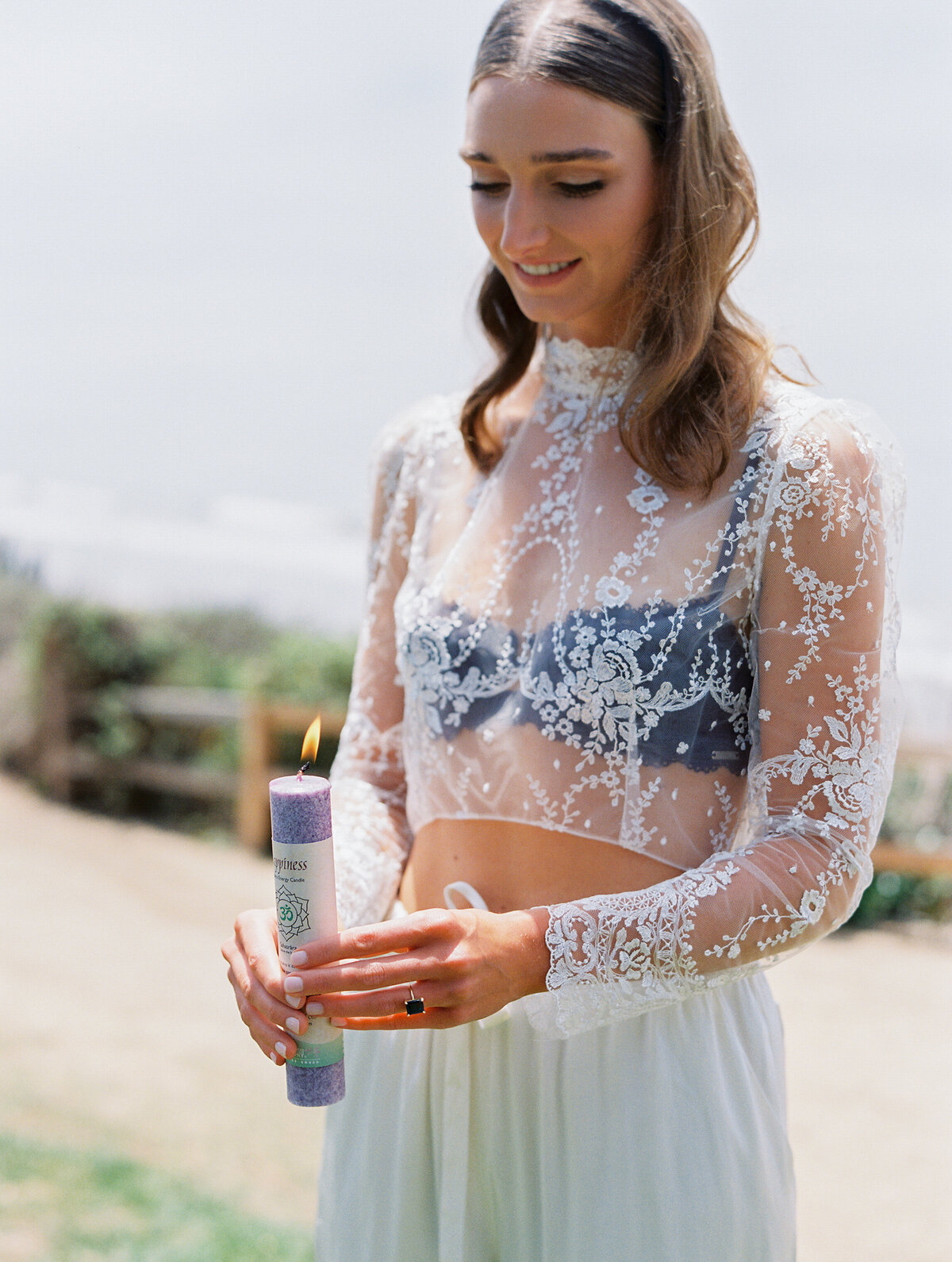 purple candle being lit during wedding ceremony