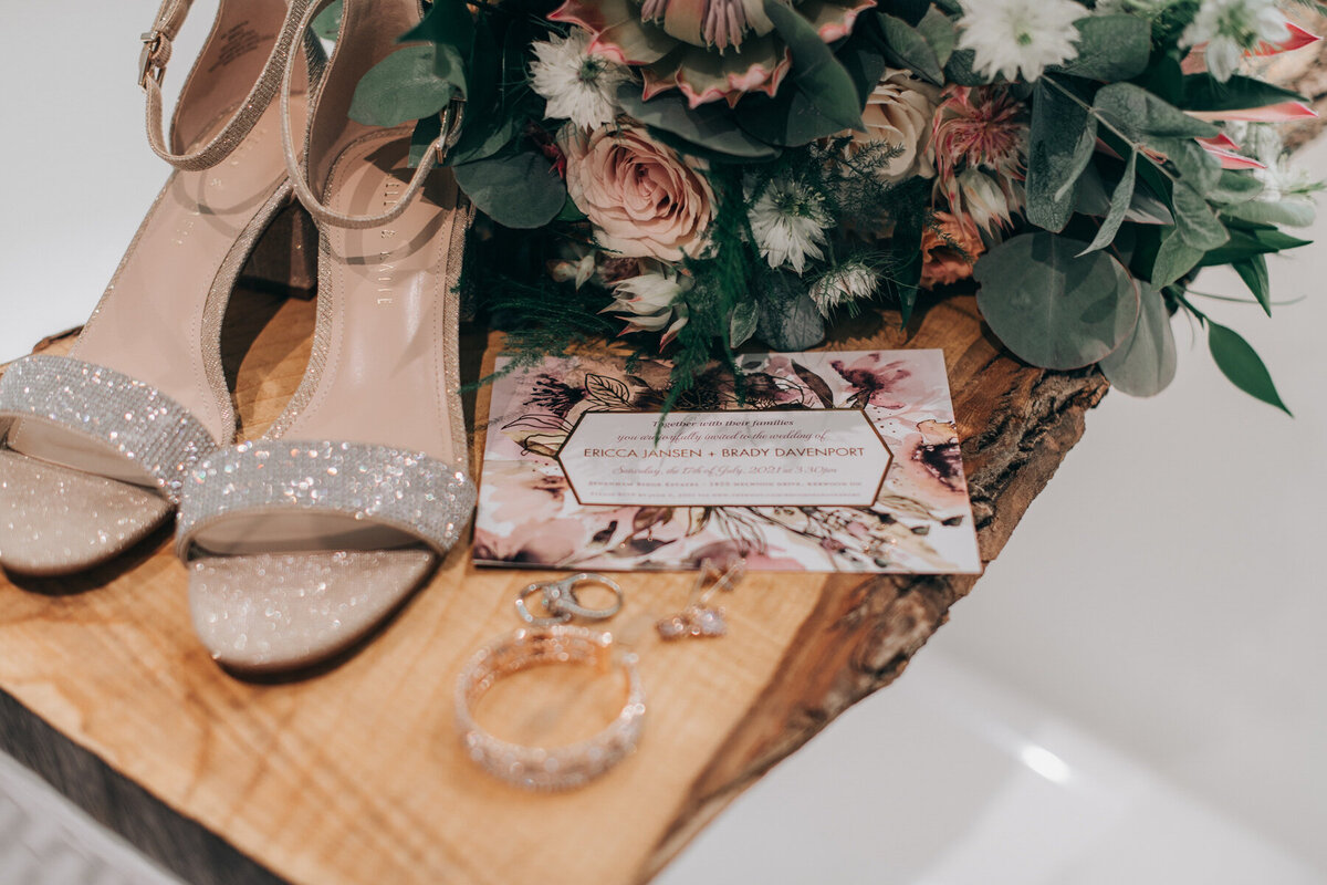 Romantic detail photo of the brides details including her shoes, the bouquet, jewellery and the wedding invitation