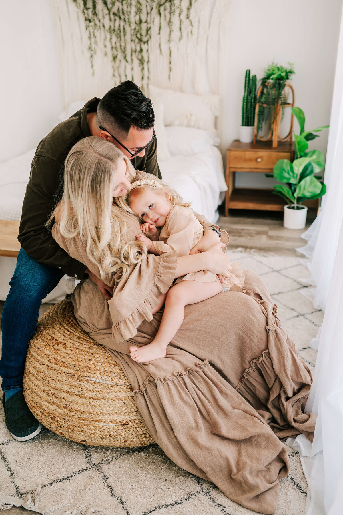 family hugging on bedside during Branson MO family photography session in studio
