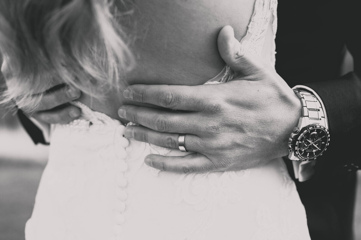 groom's hands on bride's waist
