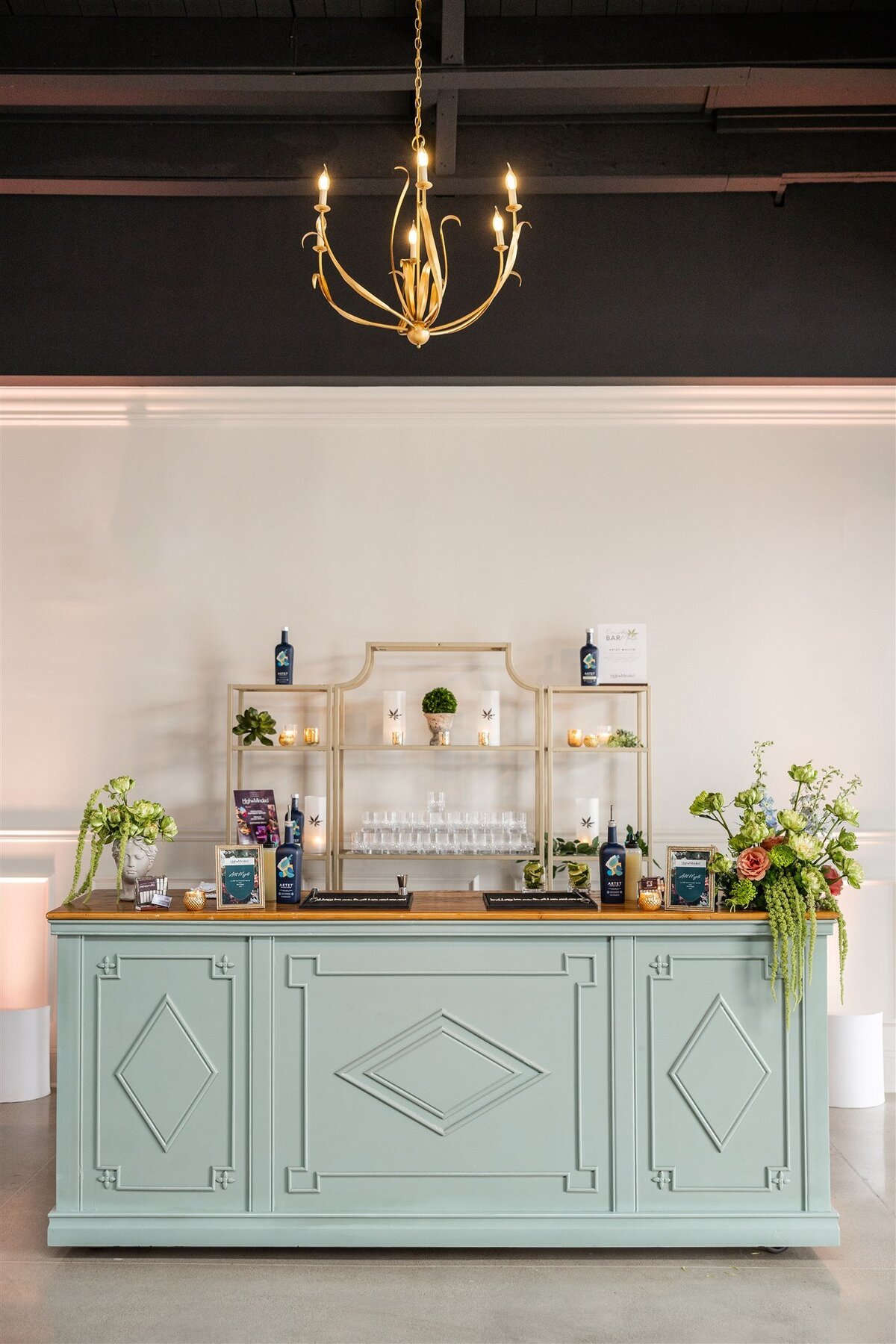 Event space styled with a Baroque theme, featuring ornate gold accents, rich fabrics, grand chandeliers, and intricate moldings, creating a luxurious and dramatic atmosphere
