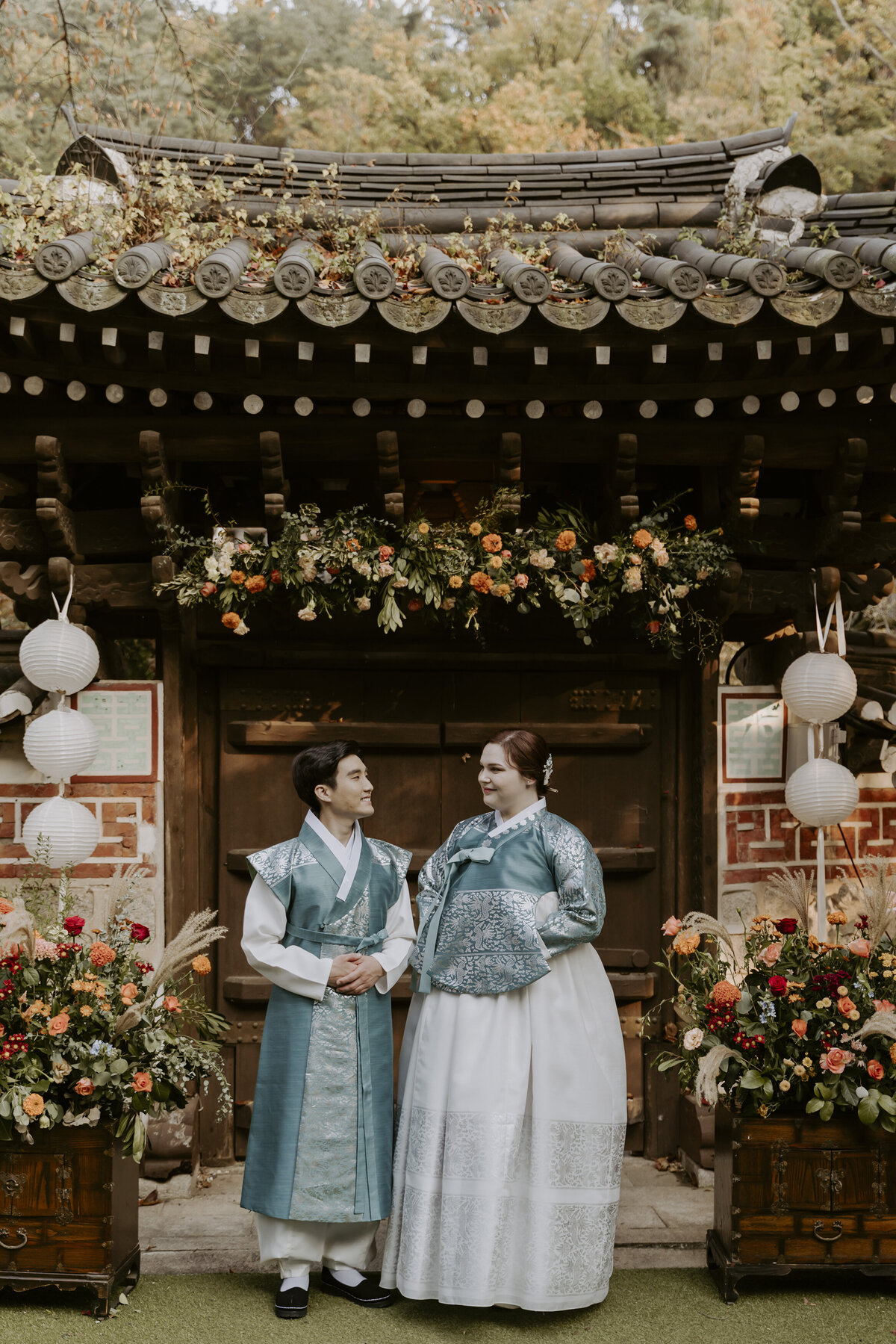 happy couple at their outdoor hanok wedding in seoul
