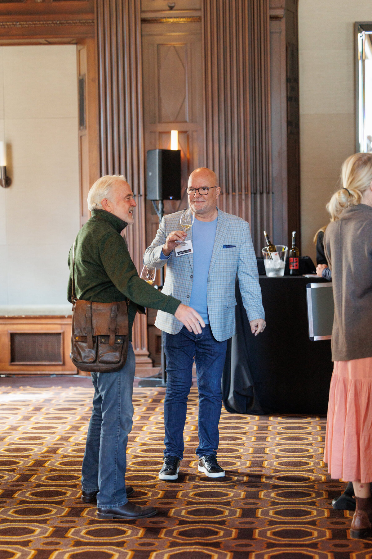 two males talking and drinking