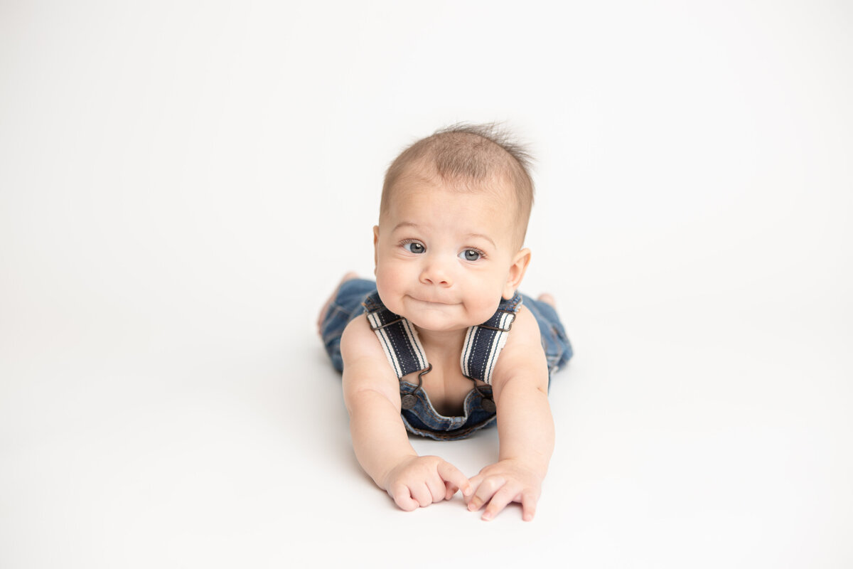 Studio portrait of a little boy in jean overalls