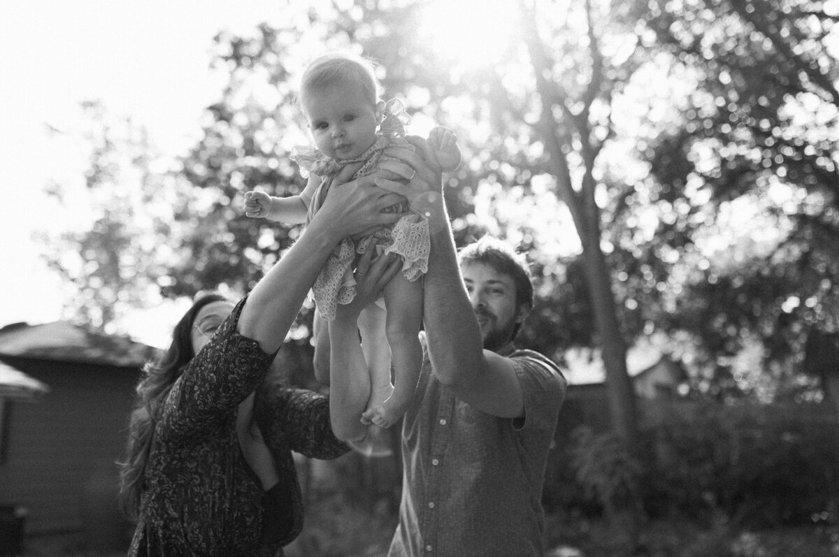 Parents lifting child into air at Austin family photo session