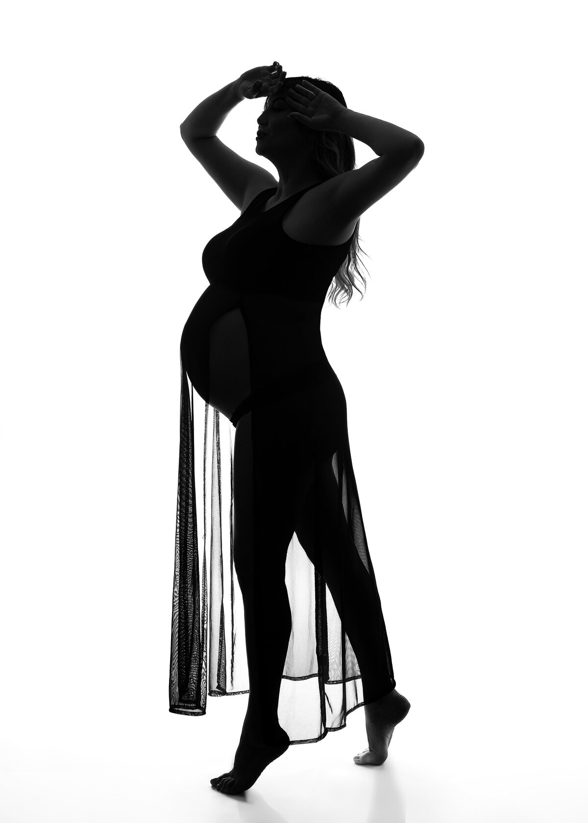 Maternity mom on her tippy toes for black and white iconic photoshoot