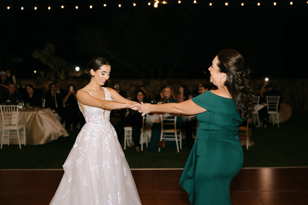bride dancing with mom at bella collina wedding venue​