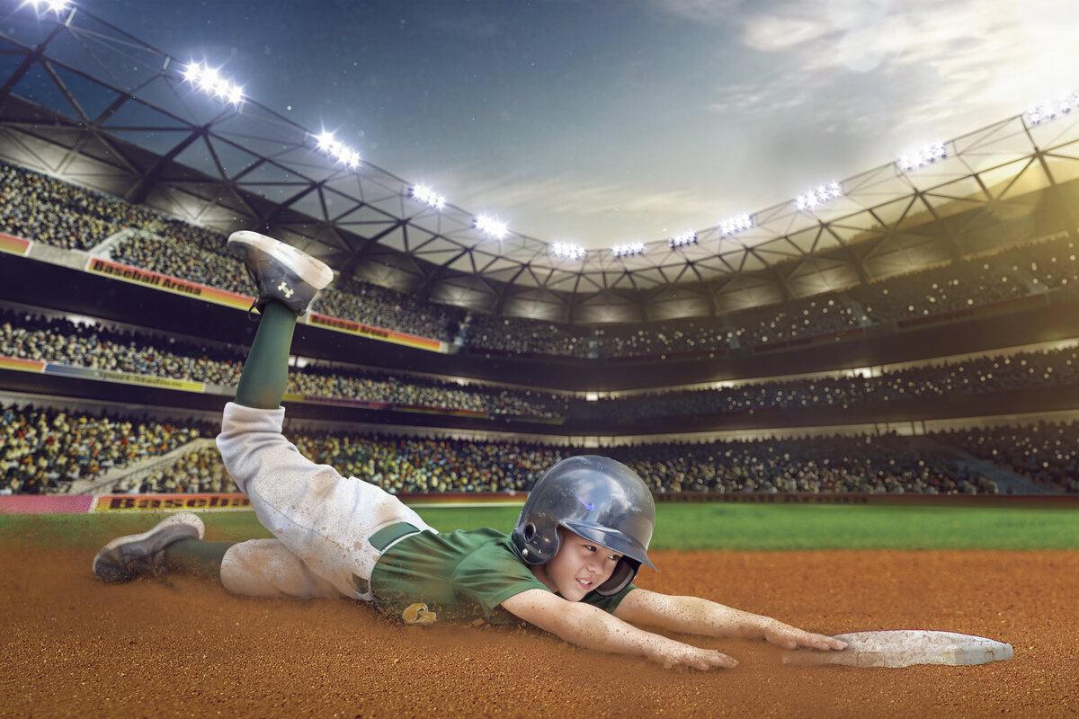 Baseball player sliding to the plate in a stadium