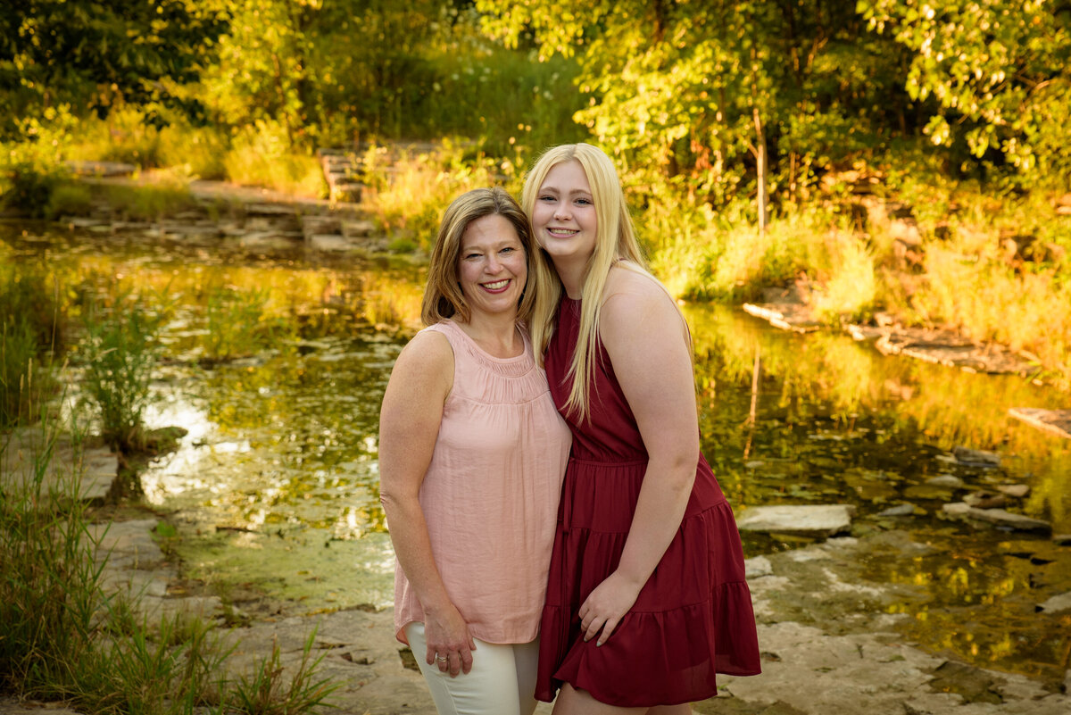 Mother and daughter portrait standing with arms around each other near the creek at Fonferek Glen County Park near Green Bay, Wisconsin
