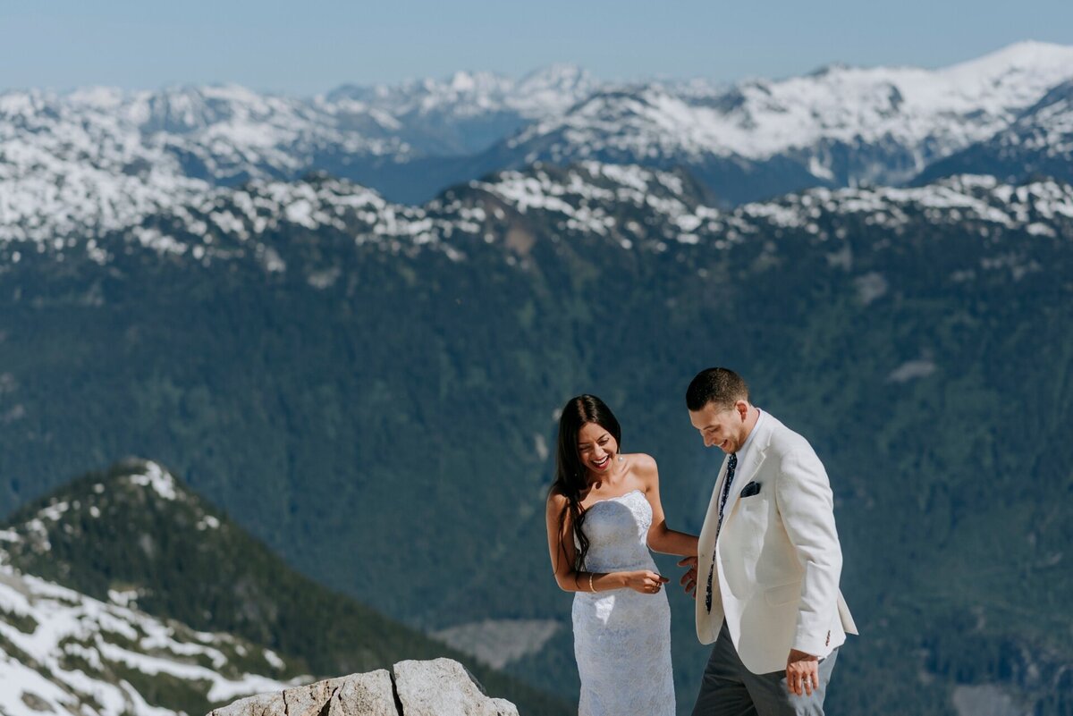 Elopement couple in Whistler stands on top of Rainbow Glacier after flying with Blackcomb Helicopters