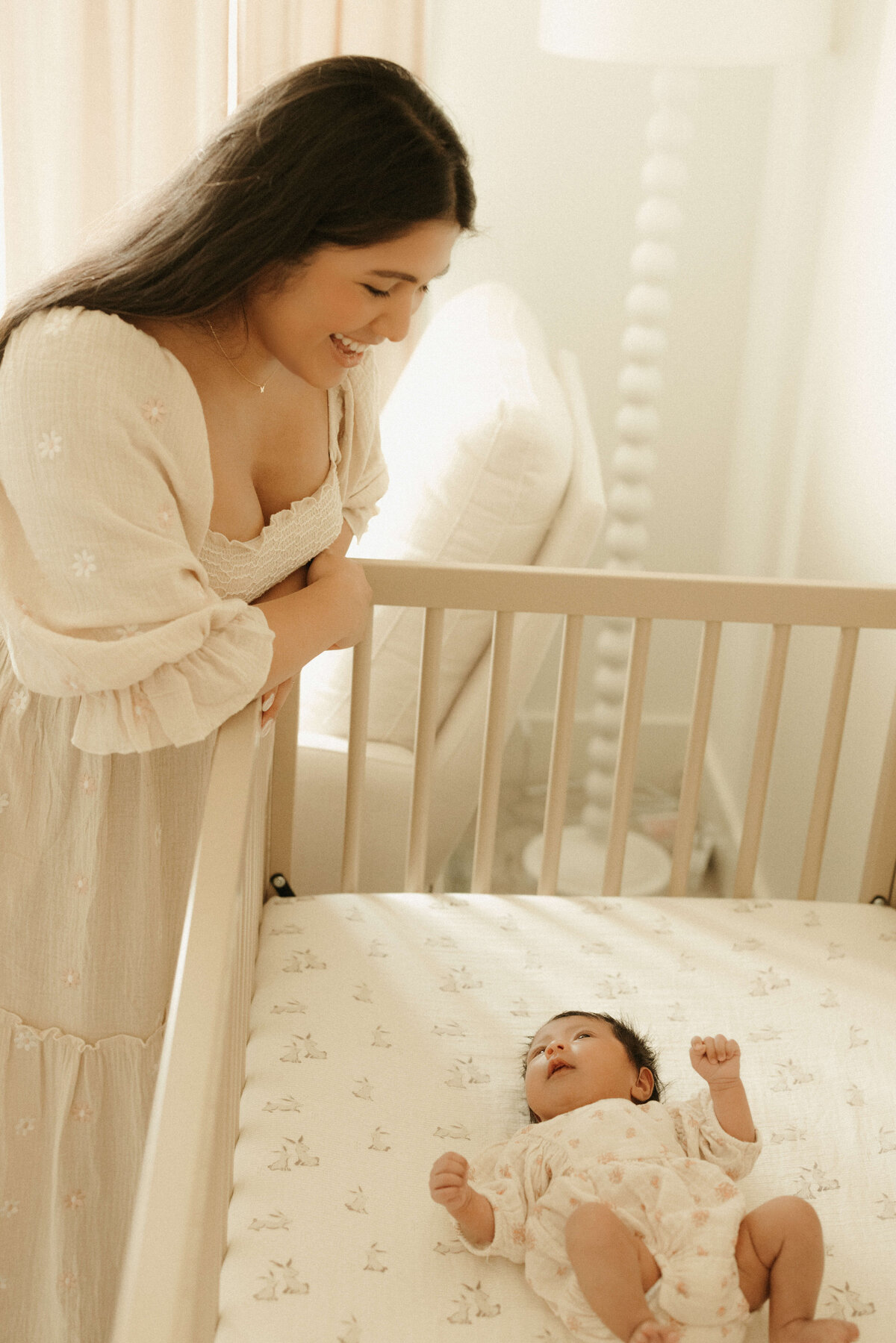 Newborn sleeping on bed during cozy in-home photography session in Franklin TN