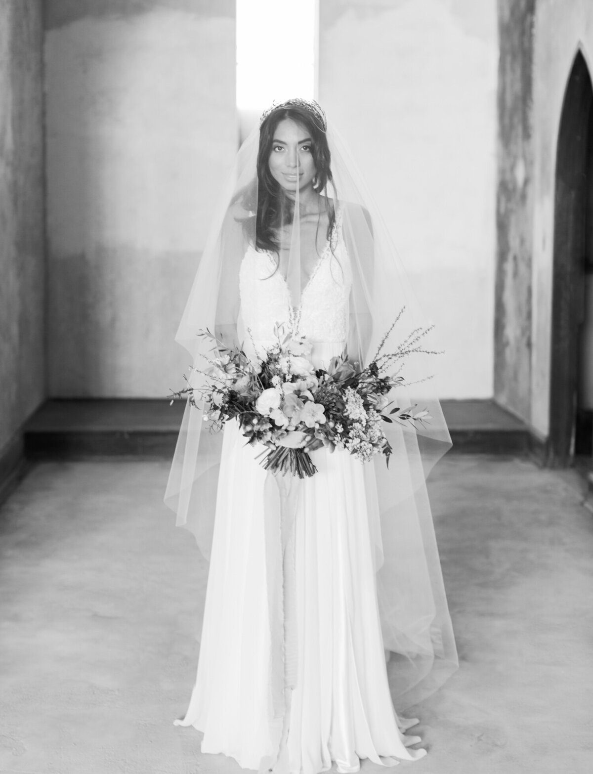 bride in long veil with blusher, ruins wedding venue in Greece