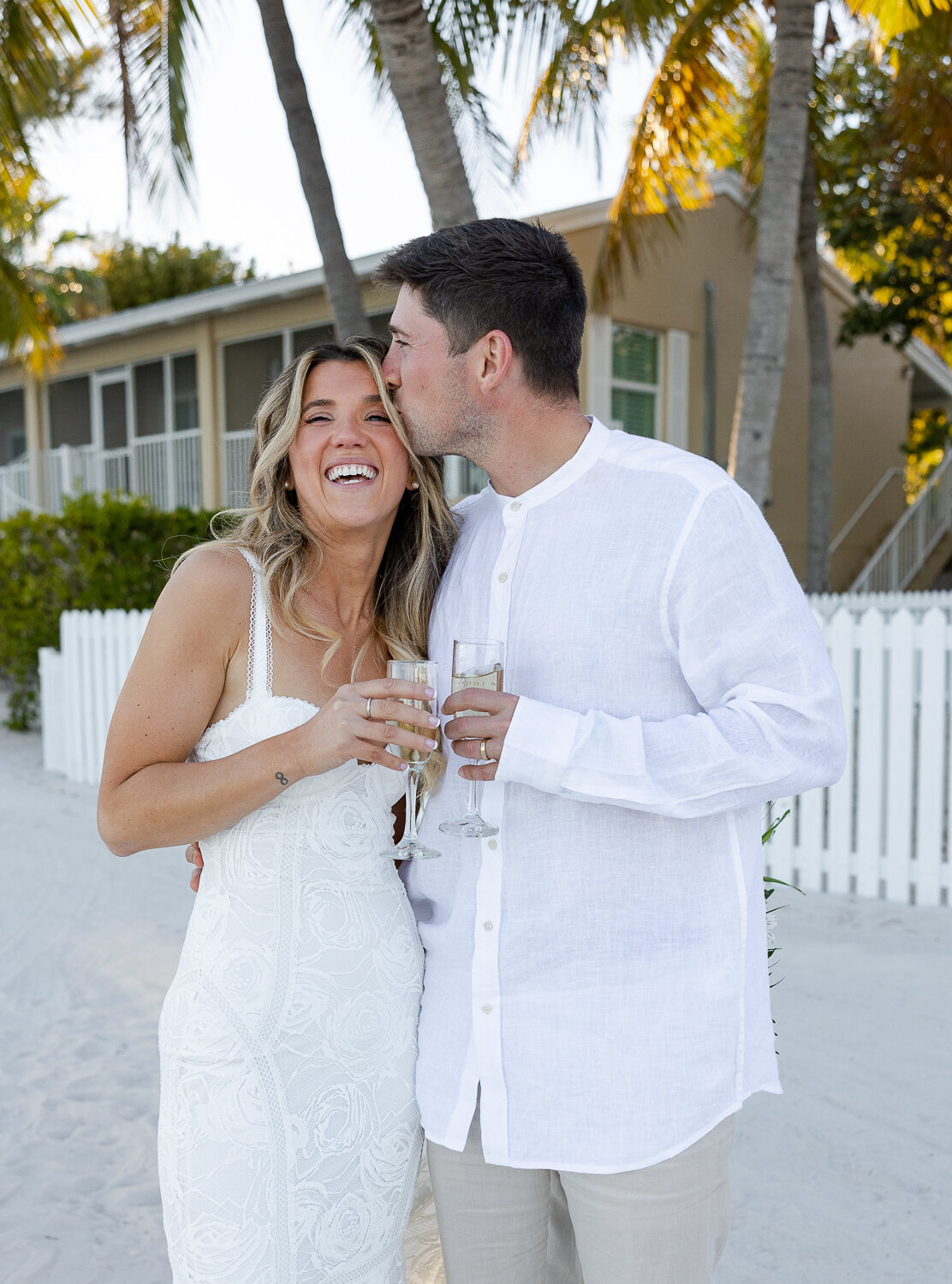 Bride Laura and groom Abraham celebrating their wedding day under the palm trees at Cheeca Lodge Resort.