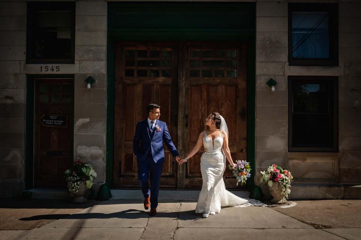 The sun lights up a bride and groom outside The Firehouse wedding venue in Chicago.