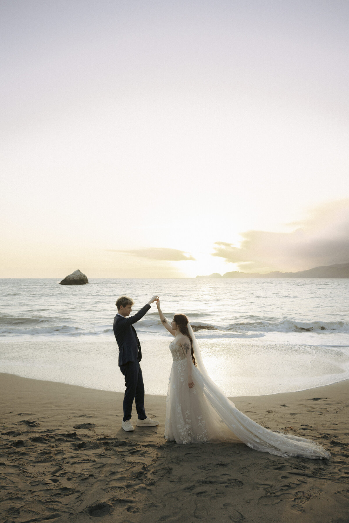 Bride and Groom at Marshall's Beach in San Francisco, California at sunset