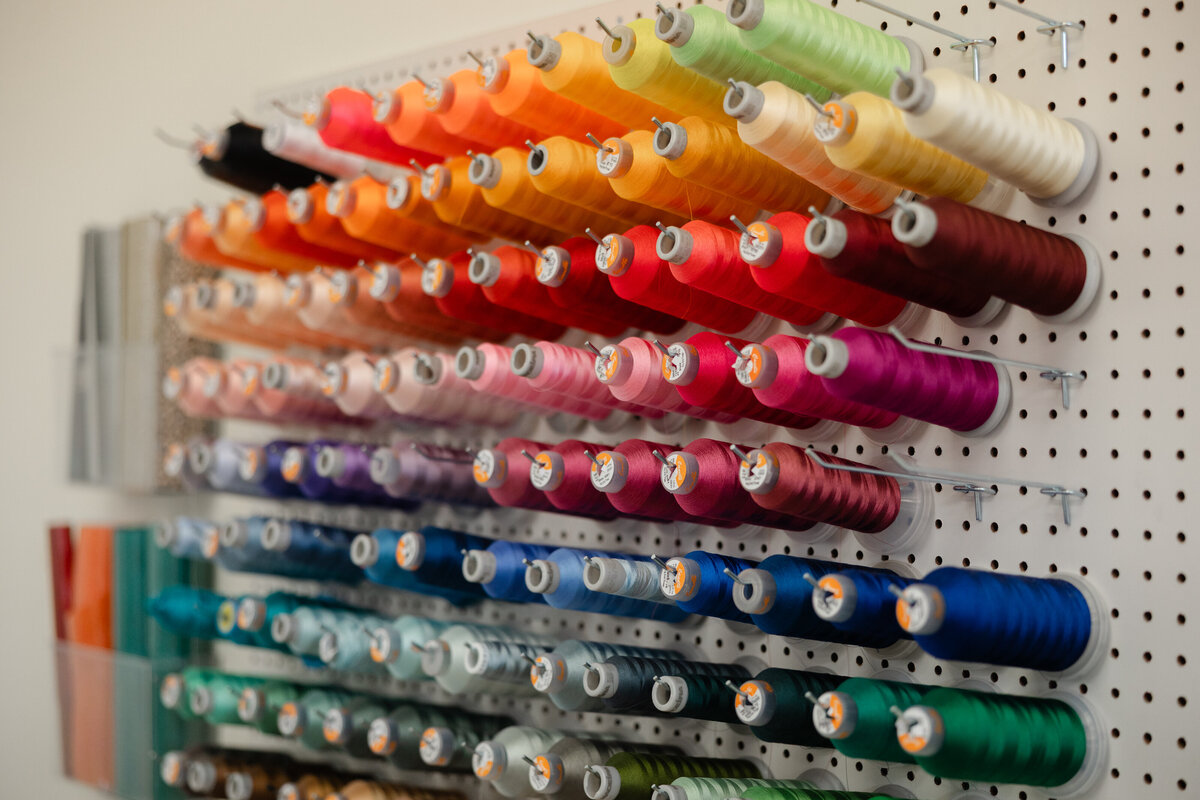 Embroidery machine creating a custom stitched design. Photograph by Yucaipa branding photographer Kaitlyn Dawn Photography.