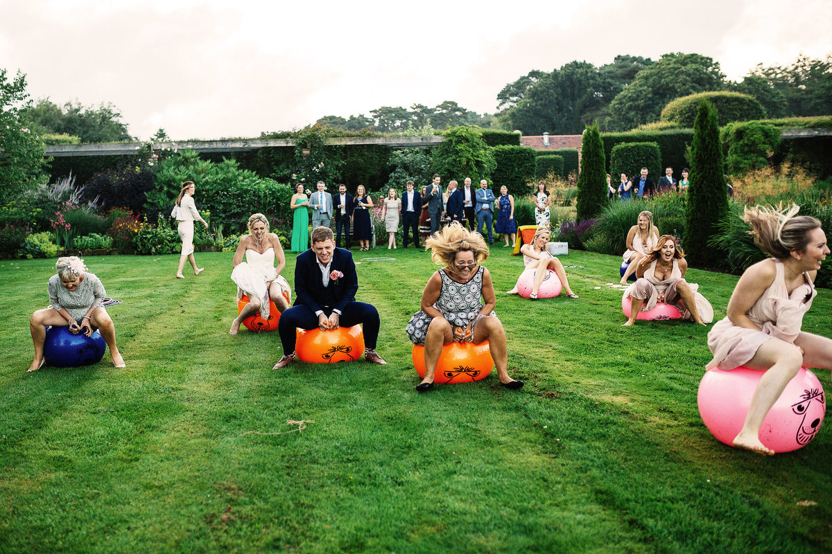 Wedding Guests having a space hopper race at Abbeywood Estate